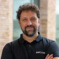 Loic Aigon, Product Manager at Enfocus, wearing an Enfocus polo shirt with arms crossed indoors